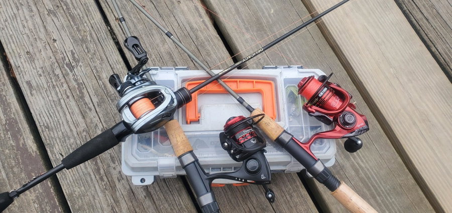 Two ultra-light fishing rods and reels on a tackle box.